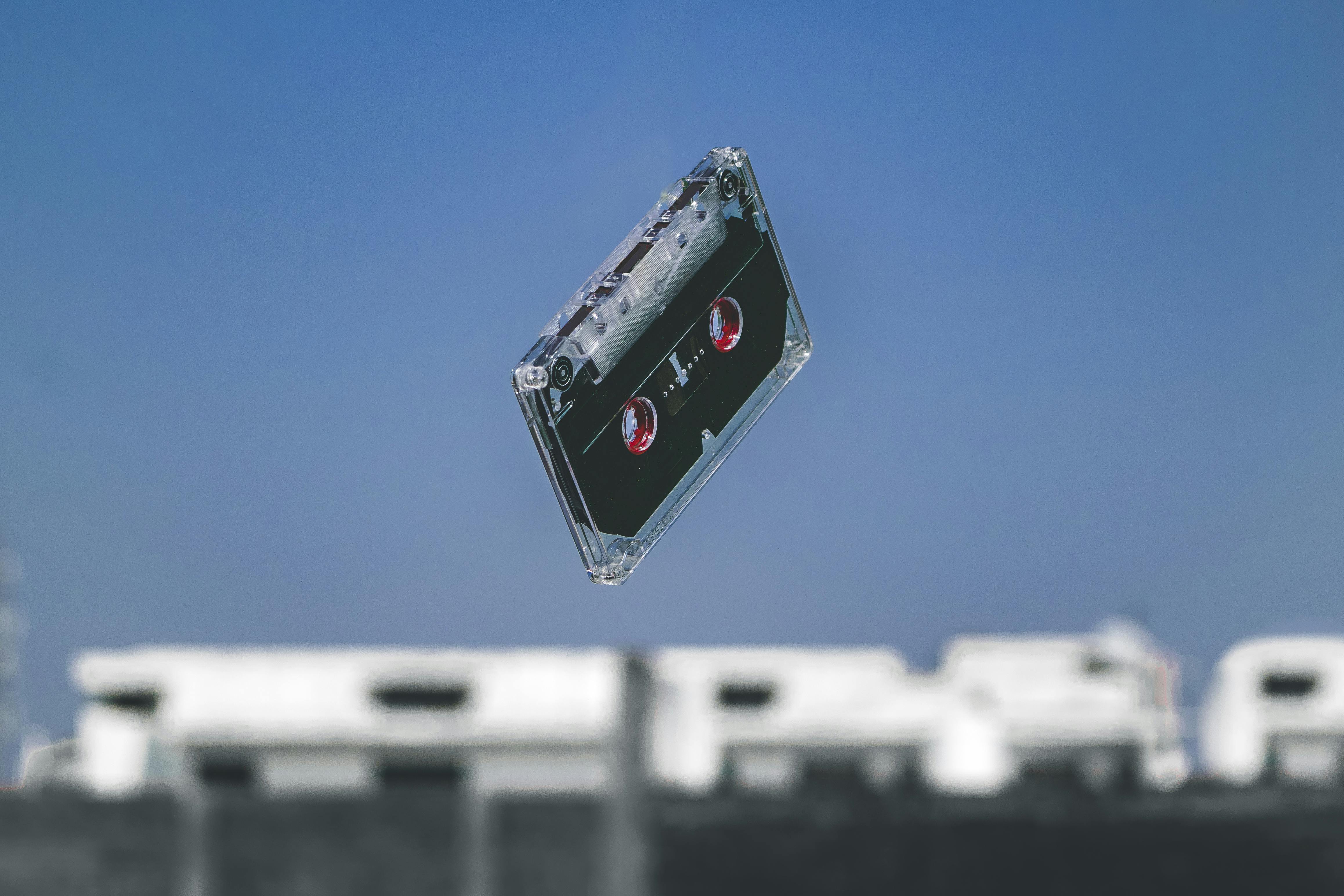 black cassette tape in mid air